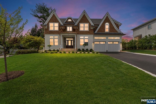229 Bogert Pl, Paramus, NJ 07652 - view of front of property featuring a garage, driveway, and a front yard