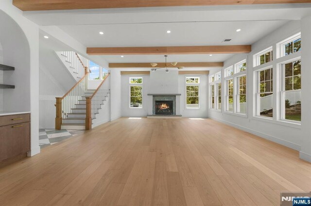 229 Bogert Pl, Paramus, NJ 07652 - unfurnished living room featuring visible vents, light wood finished floors, beam ceiling, and stairway