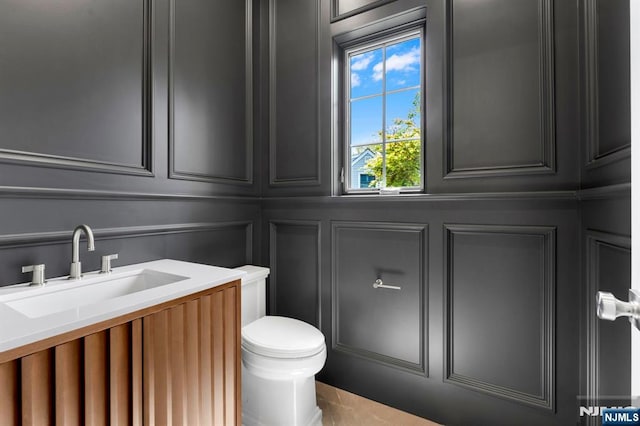 229 Bogert Pl, Paramus, NJ 07652 - half bath with vanity, a decorative wall, and toilet