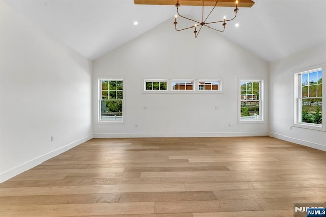 229 Bogert Pl, Paramus, NJ 07652 - unfurnished living room with an inviting chandelier, light wood-style floors, high vaulted ceiling, recessed lighting, and baseboards