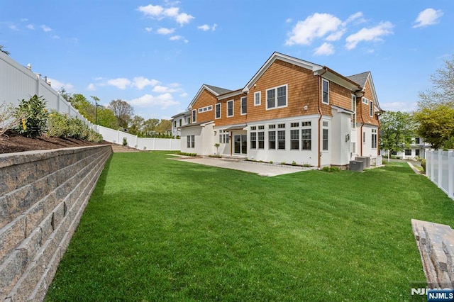229 Bogert Pl, Paramus, NJ 07652 - rear view of property with a lawn, a fenced backyard, and a patio area