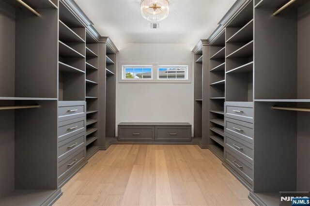 229 Bogert Pl, Paramus, NJ 07652 - spacious closet featuring a chandelier, visible vents, and light wood-type flooring