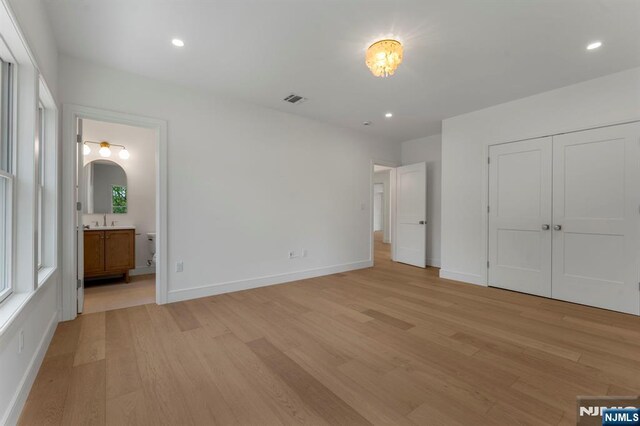229 Bogert Pl, Paramus, NJ 07652 - unfurnished bedroom with visible vents, a sink, light wood-style flooring, and baseboards