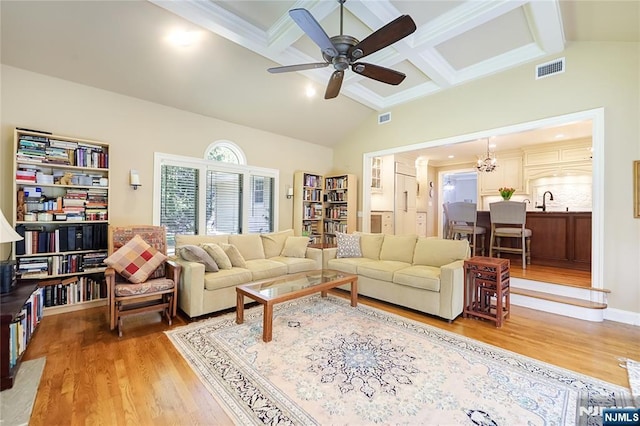 living area featuring a ceiling fan, visible vents, lofted ceiling with beams, and light wood-type flooring