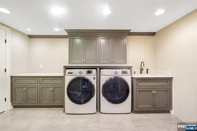 washroom featuring washing machine and dryer, recessed lighting, a sink, cabinet space, and light tile patterned floors