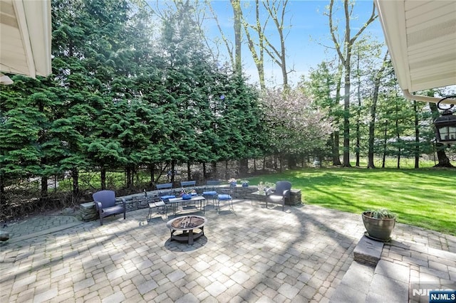 view of patio / terrace featuring an outdoor fire pit