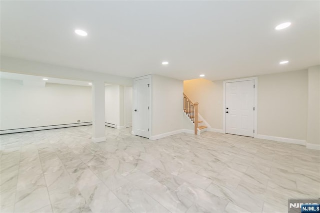 finished basement featuring recessed lighting, baseboards, stairway, and a baseboard radiator