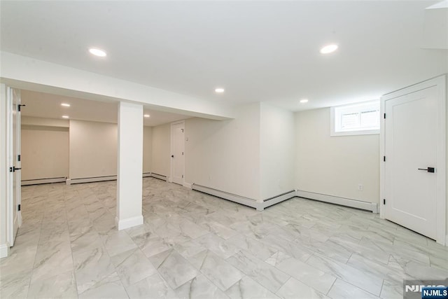 below grade area with marble finish floor, baseboards, recessed lighting, a baseboard heating unit, and a baseboard radiator