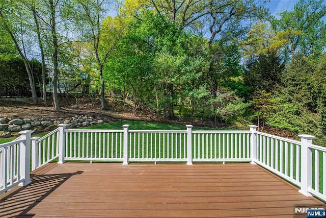 wooden deck featuring a yard