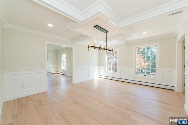 unfurnished dining area featuring crown molding, light wood-type flooring, a baseboard heating unit, a notable chandelier, and a decorative wall