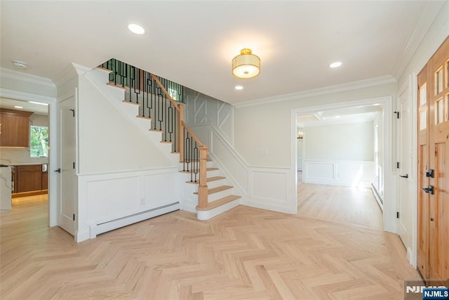 stairs featuring crown molding, a decorative wall, a wainscoted wall, recessed lighting, and a baseboard heating unit