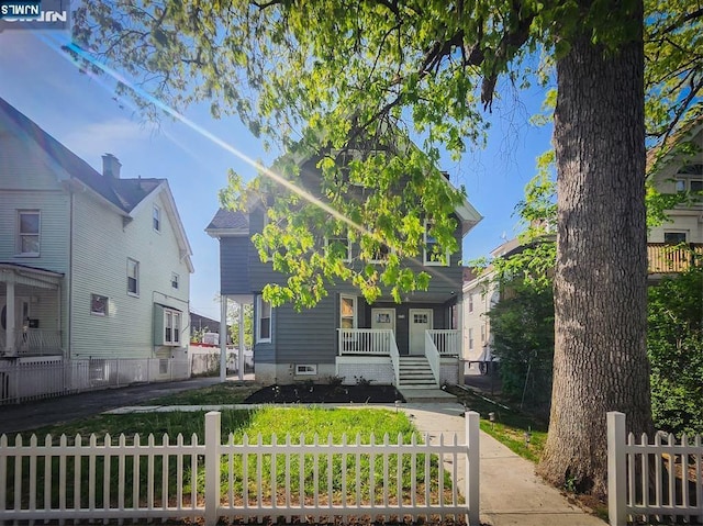 view of front of property with fence private yard and a porch