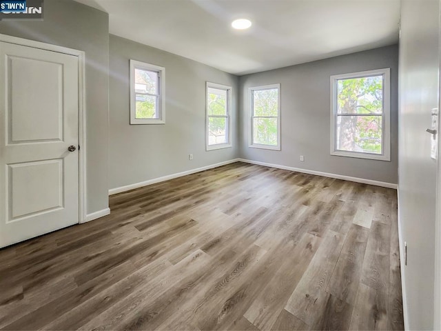 interior space featuring baseboards, recessed lighting, and wood finished floors