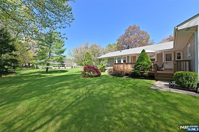 view of yard with a wooden deck