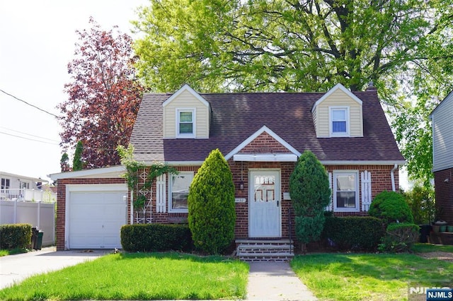 cape cod home with concrete driveway, brick siding, a front yard, and a garage