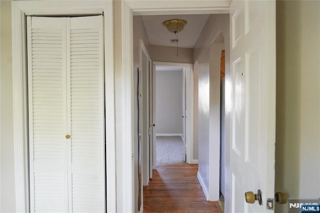 hall with baseboards and dark wood-style floors