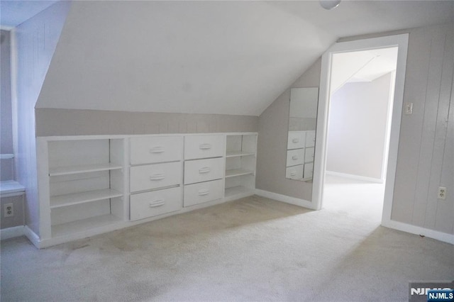 bonus room featuring carpet floors and vaulted ceiling
