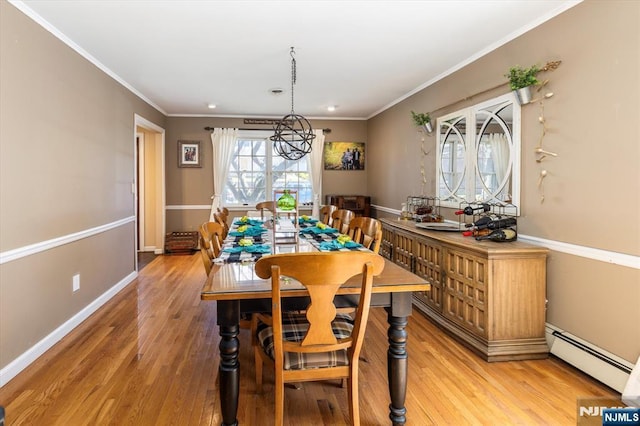 444 Washington St, Carlstadt, NJ 07072 - dining space featuring a baseboard radiator, light wood-style flooring, baseboards, and ornamental molding