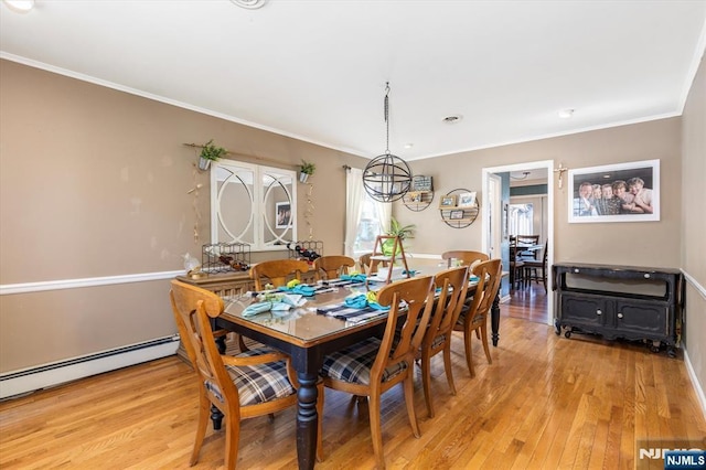 444 Washington St, Carlstadt, NJ 07072 - dining area with light wood-type flooring, ornamental molding, a baseboard radiator, and a chandelier