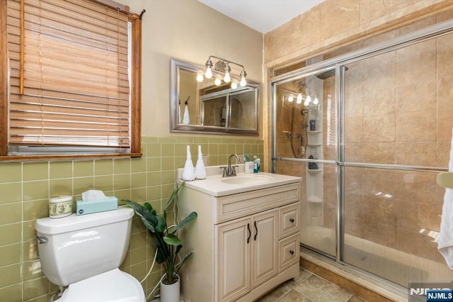 444 Washington St, Carlstadt, NJ 07072 - full bath featuring a shower stall, tile walls, toilet, and vanity