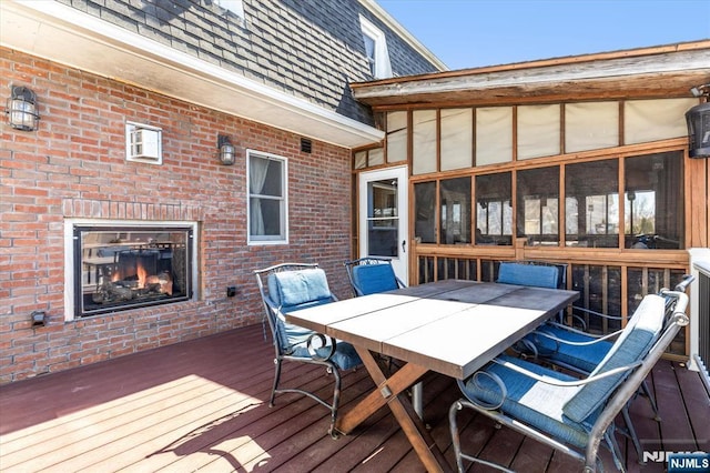 444 Washington St, Carlstadt, NJ 07072 - wooden deck with a warm lit fireplace and outdoor dining space