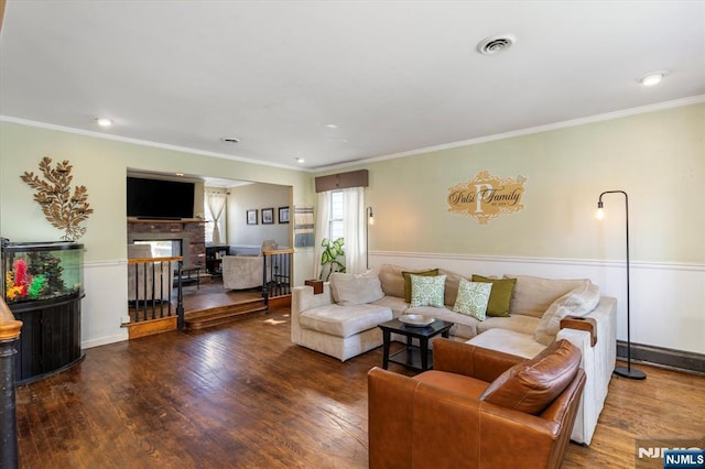 444 Washington St, Carlstadt, NJ 07072 - living area featuring a fireplace, wood finished floors, ornamental molding, and recessed lighting