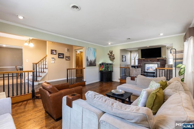 444 Washington St, Carlstadt, NJ 07072 - living area with a multi sided fireplace, wood finished floors, crown molding, stairs, and recessed lighting