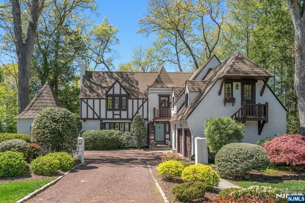 732 Parsons Rd, Ridgewood, NJ 07450 - tudor-style house with stucco siding, a chimney, driveway, and a balcony