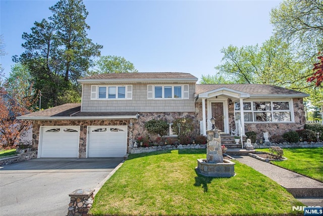 split level home with driveway, stone siding, and a front lawn