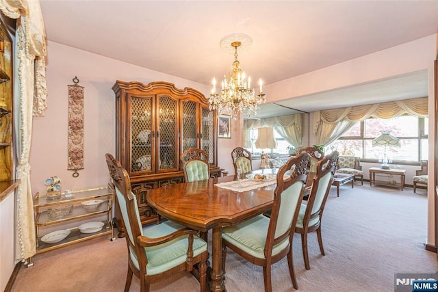 carpeted dining area with a notable chandelier