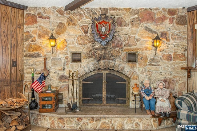 details with a fireplace, a textured ceiling, and visible vents