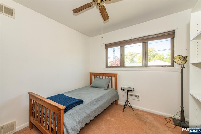 carpeted bedroom featuring visible vents, a ceiling fan, and baseboards