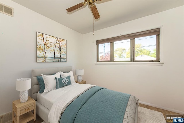 bedroom featuring visible vents, a ceiling fan, and baseboards