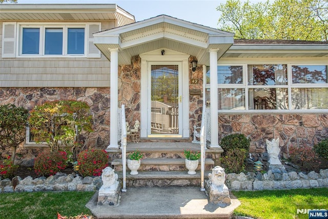 doorway to property featuring stone siding