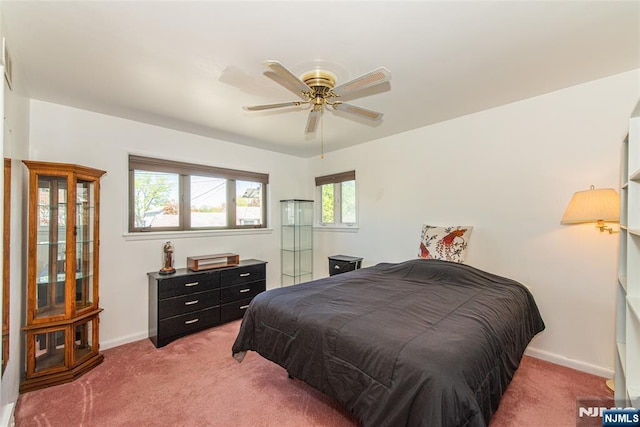 bedroom featuring baseboards, ceiling fan, and light colored carpet