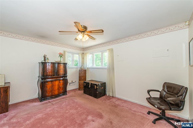 living area featuring baseboards, a ceiling fan, and carpet flooring