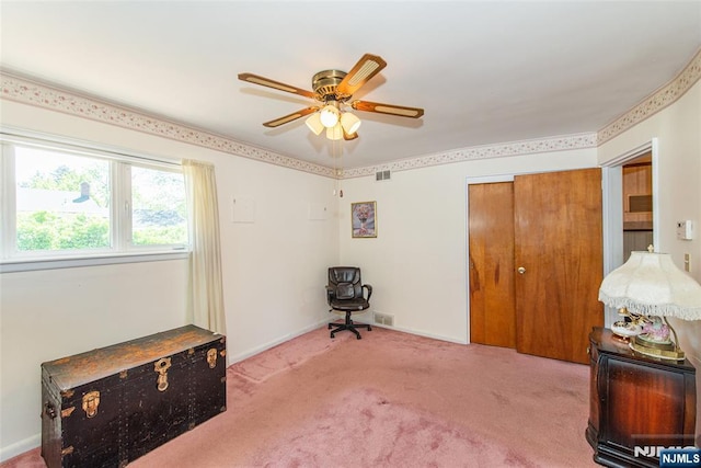 living area with carpet floors, a ceiling fan, baseboards, and visible vents