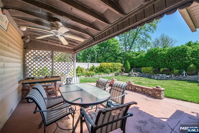 view of patio / terrace with ceiling fan, fence, and outdoor dining space