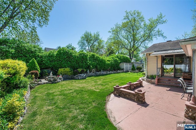 view of yard with an outdoor structure and a patio area