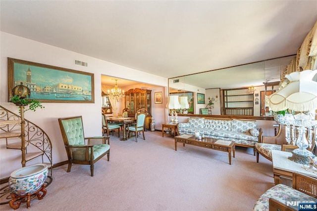 living area featuring an inviting chandelier, baseboards, carpet, and visible vents