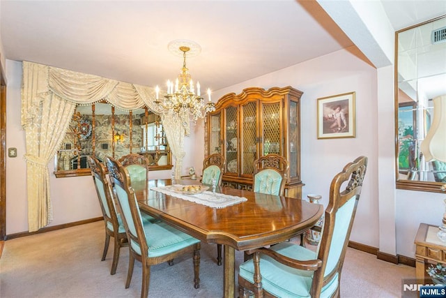dining space featuring an inviting chandelier, baseboards, and light colored carpet