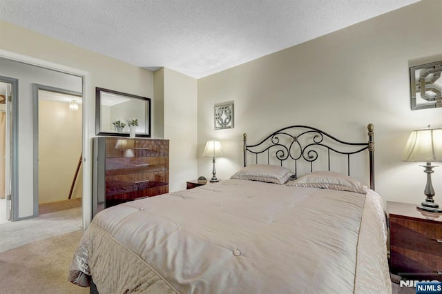 carpeted bedroom with a textured ceiling