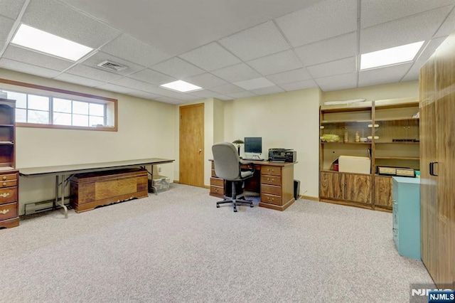 carpeted home office with a baseboard heating unit, a paneled ceiling, and visible vents
