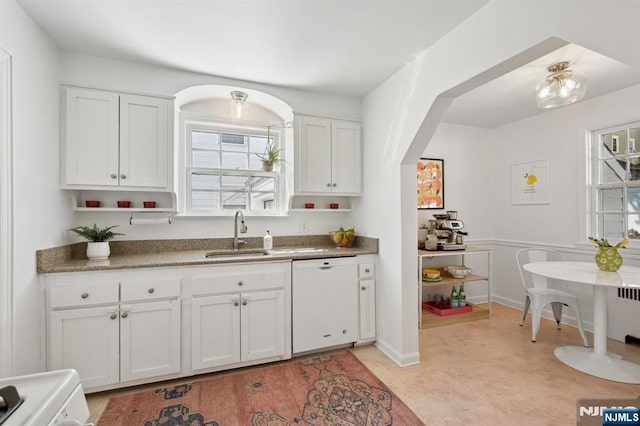 kitchen with white cabinets, a wealth of natural light, a sink, and dishwasher