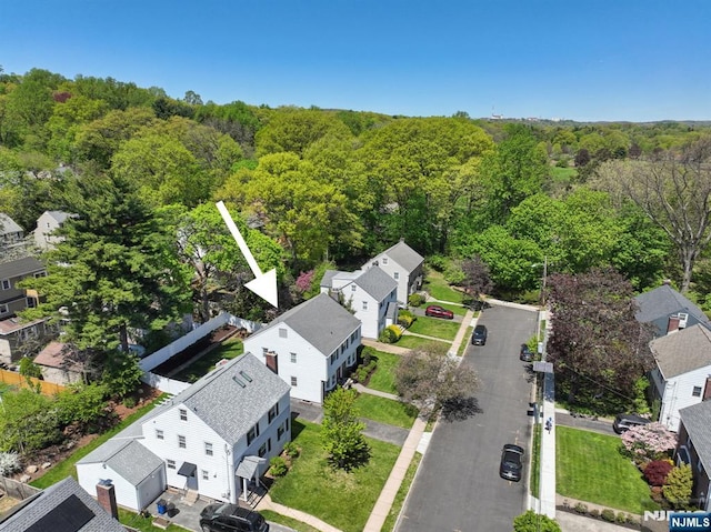 birds eye view of property with a residential view and a view of trees