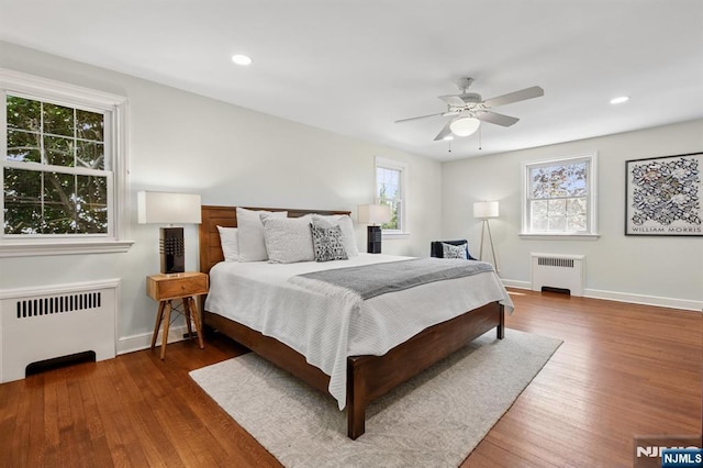 bedroom with wood finished floors and radiator