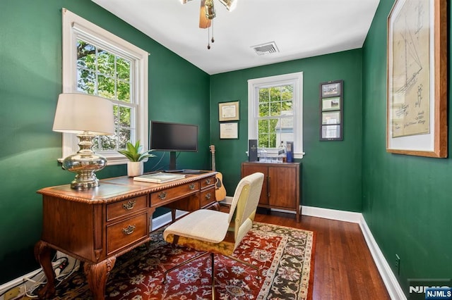 office space with baseboards, ceiling fan, wood finished floors, and visible vents