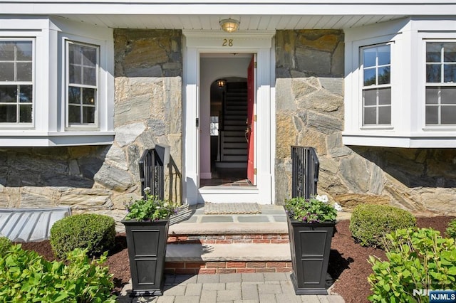 property entrance featuring stone siding