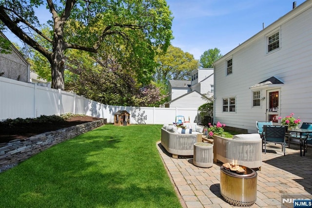 view of yard with a fenced backyard, a patio area, and an outdoor living space with a fire pit