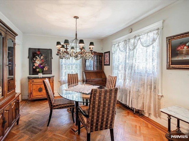 dining area featuring crown molding and a notable chandelier